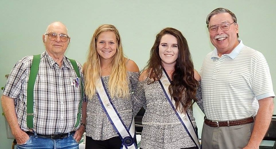Two senior men and two young women smiling