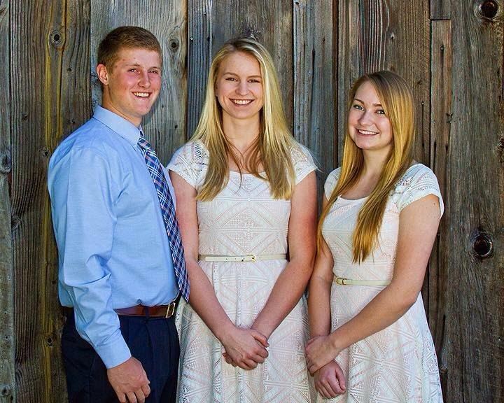Fair Ambassadors posing in front of wood wall
