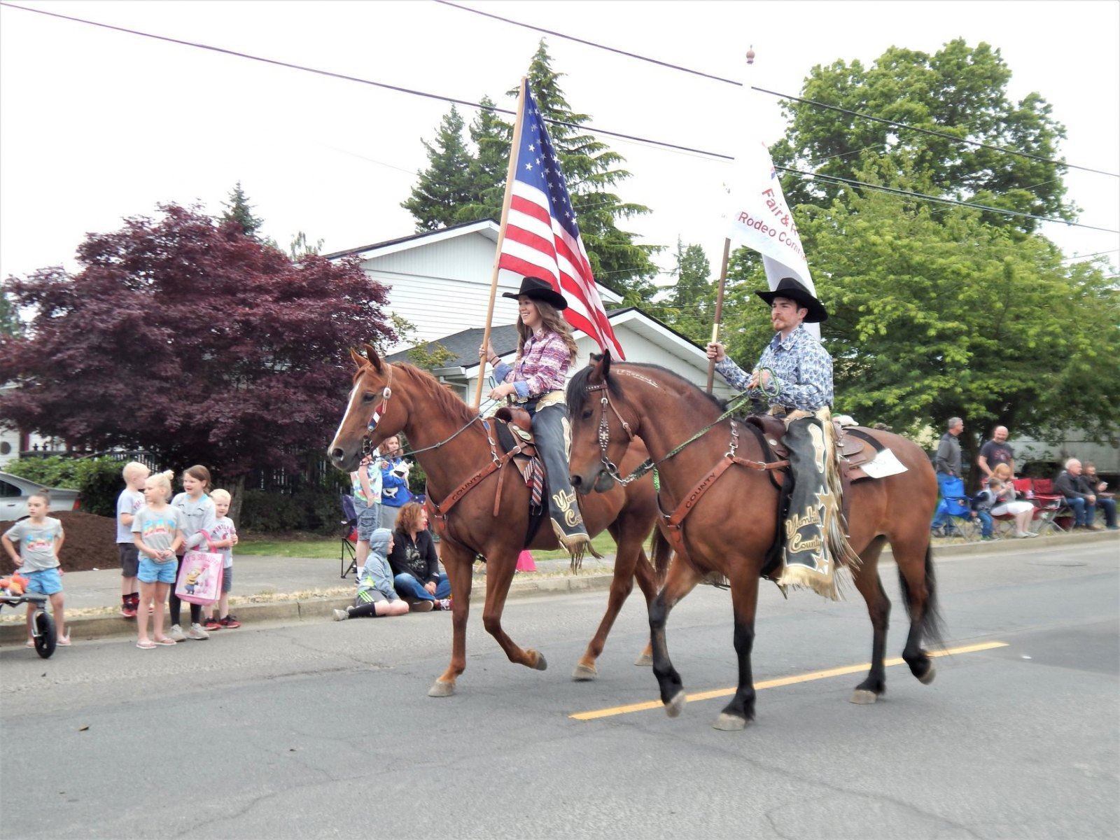 Fair Ambassadors riding horses in parade
